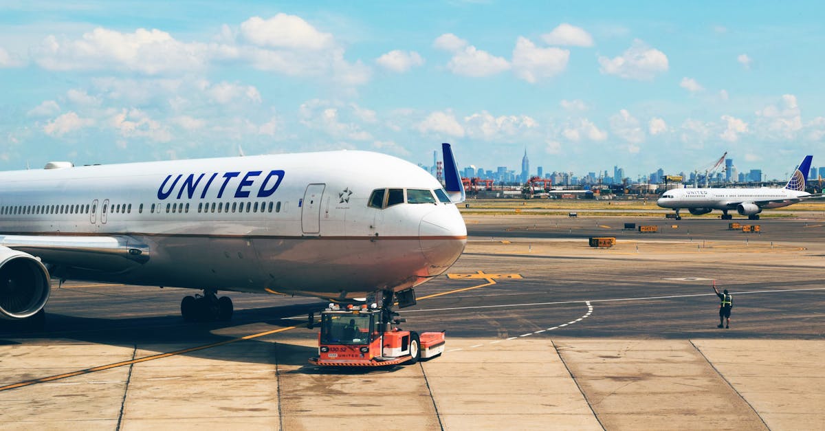 Aircraft on the runway at Newark Airport with city skyline in the background.