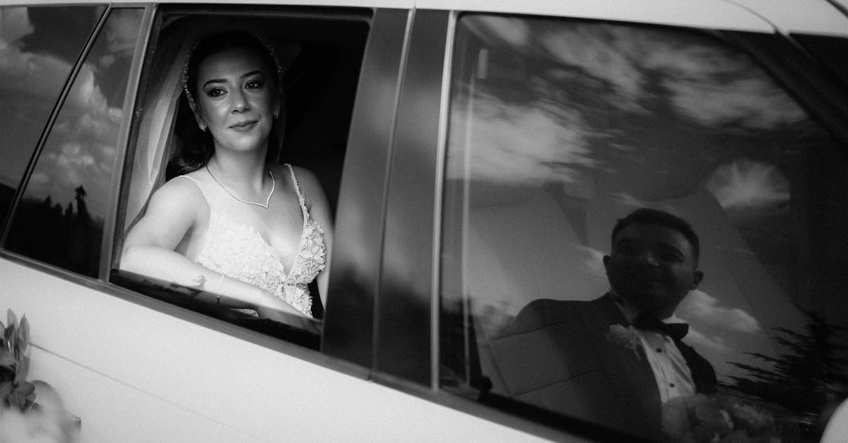 Bride and groom captured in a limousine with reflective windows during a wedding.