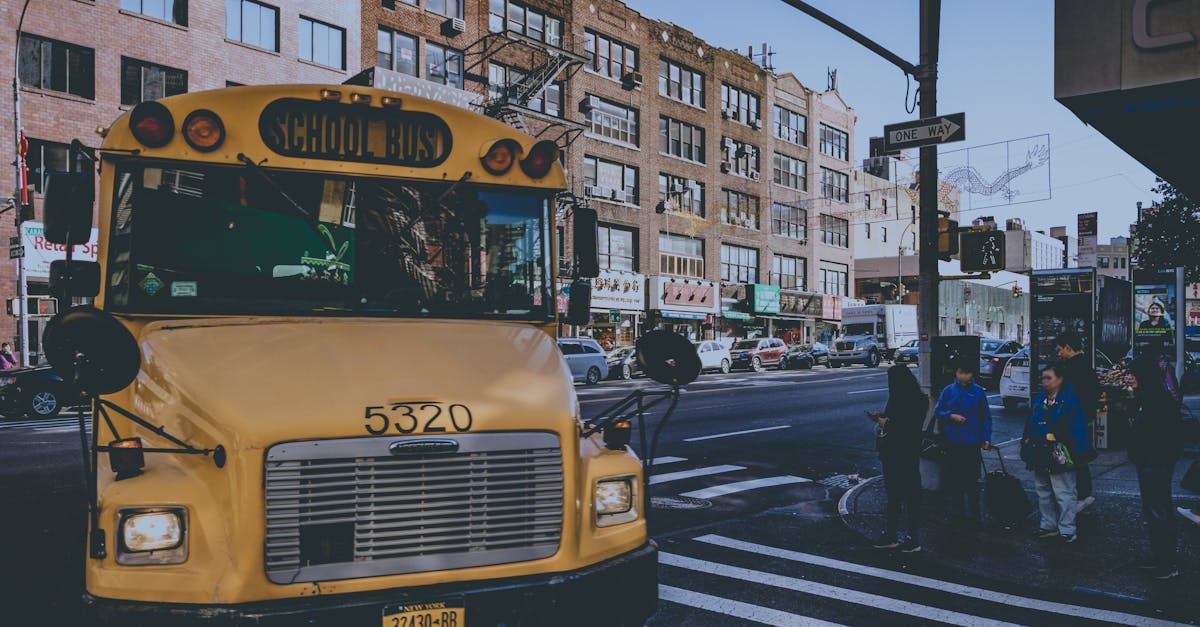 Yellow school bus on a bustling city street with pedestrians in New York.