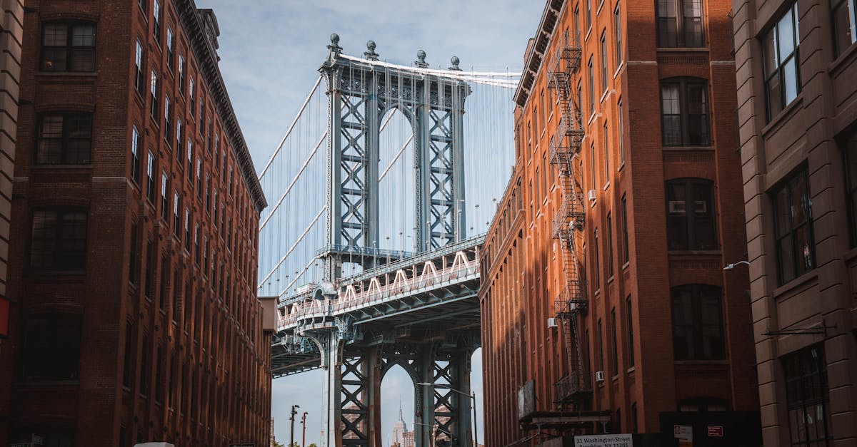 Stunning view of the Manhattan Bridge framed by red-brick buildings in New York City's DUMBO neighborhood.