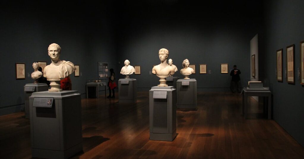 An art gallery with classical sculptures and framed art, showcasing elegant indoor lighting and design.