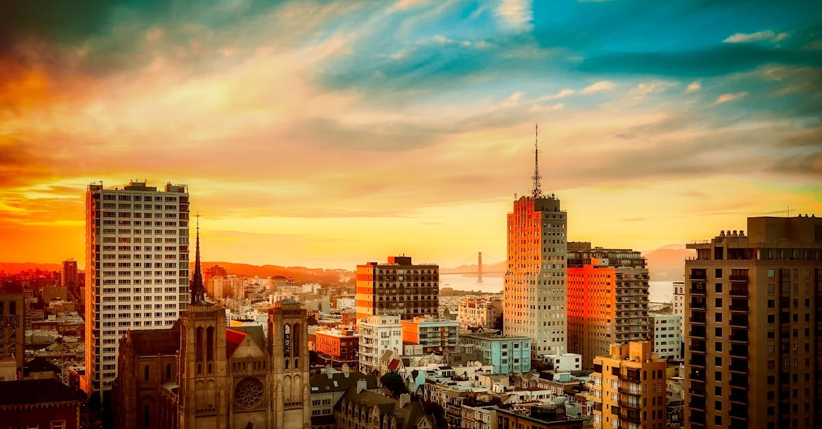 Stunning view of San Francisco cityscape with Golden Gate Bridge at sunset, vibrant urban atmosphere.