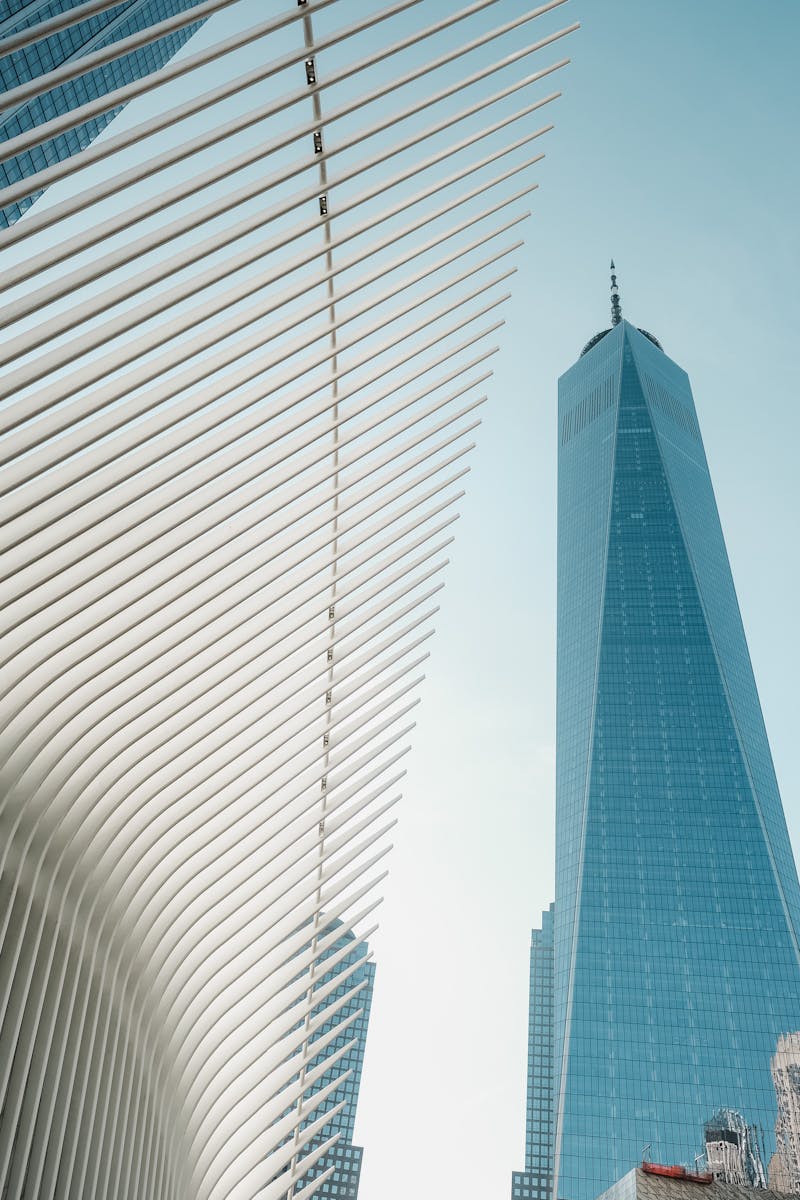 One World Trade Center and the Oculus against a clear sky in New York City.