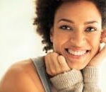 Captivating portrait of a smiling woman with a warm and friendly expression.